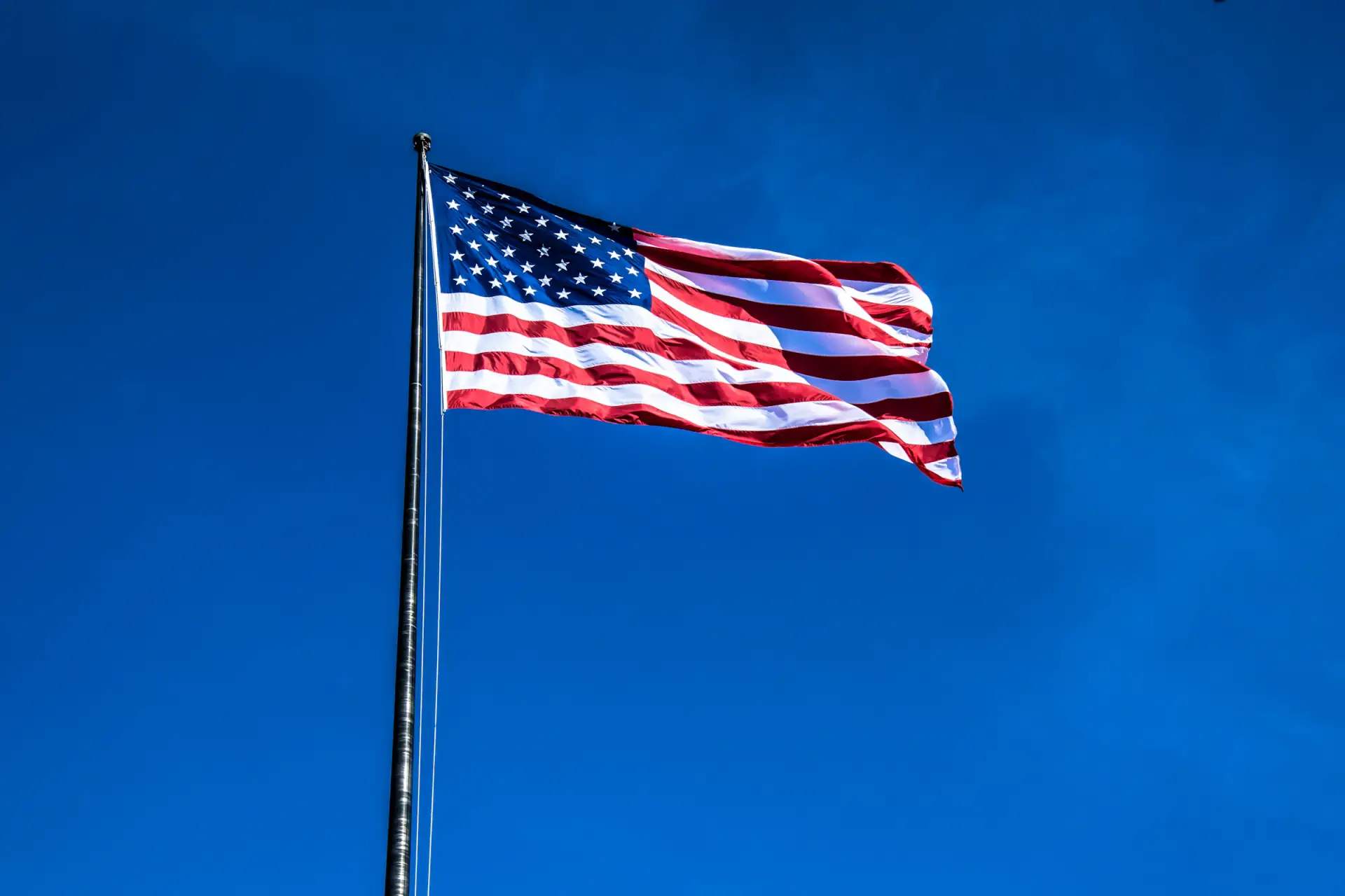 American flag flying against a clear blue sky